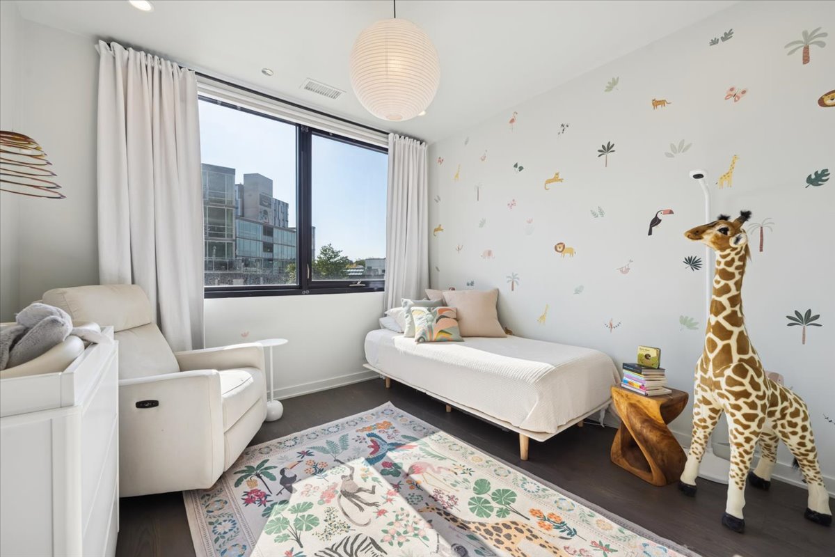 1648 West Division Street, Unit 208 Chicago, IL 60622 - Photo 33 of 48 a bedroom with a bed and wooden floor