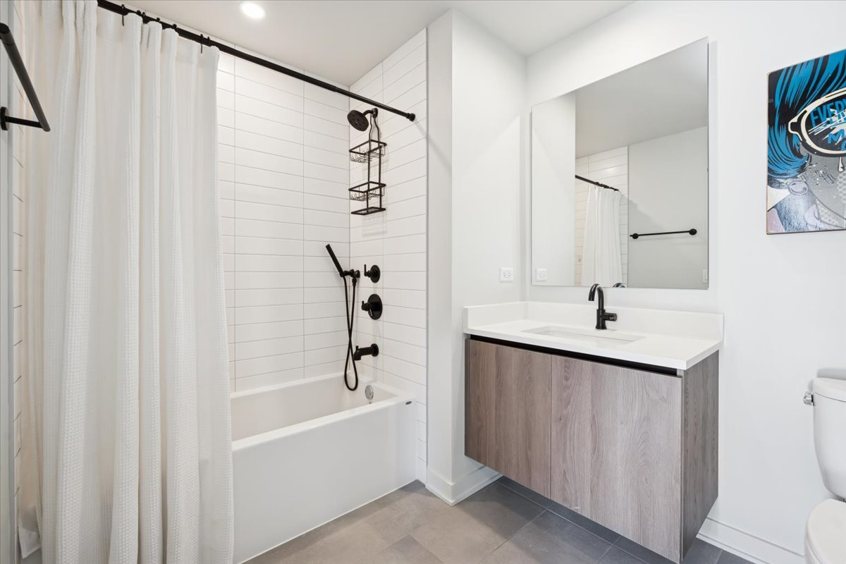 1648 West Division Street, Unit 208 Chicago, IL 60622 - Photo 34 of 48 a bathroom with a tub sink and mirror