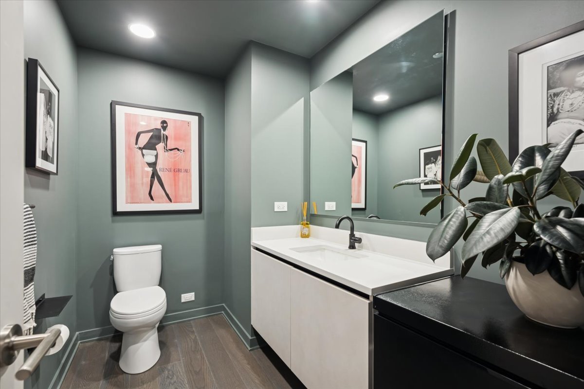 1648 West Division Street, Unit 208 Chicago, IL 60622 - Photo 36 of 48 a bathroom with a toilet a sink and mirror