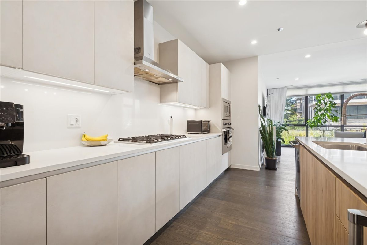 1648 West Division Street, Unit 208 Chicago, IL 60622 - Photo 4 of 48 a kitchen with stainless steel appliances a white wooden cabinets a stove a sink and a refrigerator