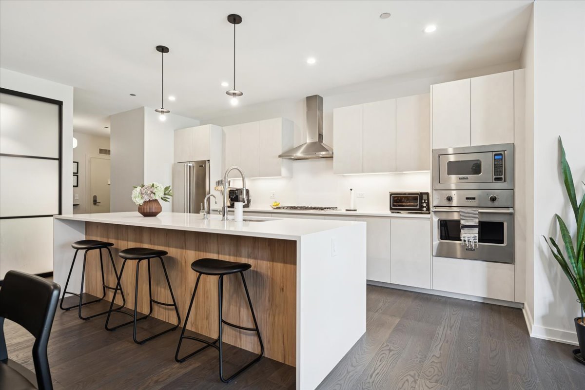 1648 West Division Street, Unit 208 Chicago, IL 60622 - Photo 7 of 48 a kitchen with stainless steel appliances kitchen island a large island in the center