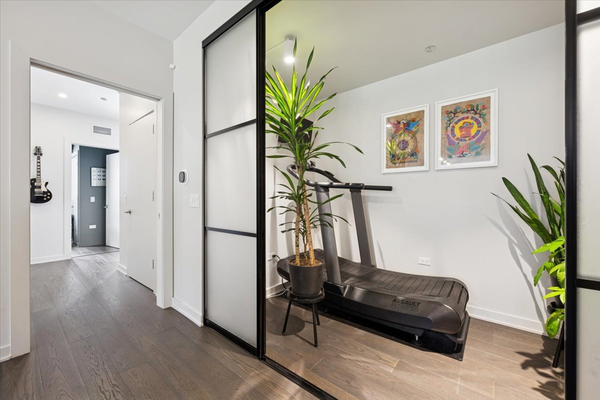 1648 West Division Street, Unit 208 Chicago, IL 60622 - Photo 10 of 48 a view of a hallway with wooden floor and a potted plant