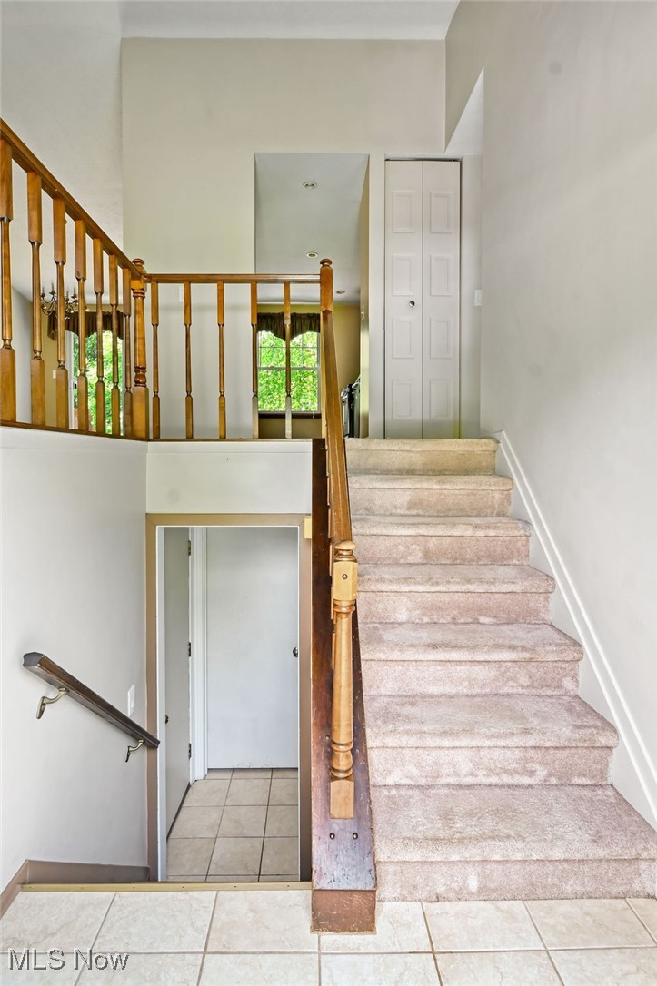 2610 Norton Road Stow, OH 44224 - Photo 8 of 41 Staircase featuring ceramic tile flooring and baseboards. Loking up to main level & down to lower level.