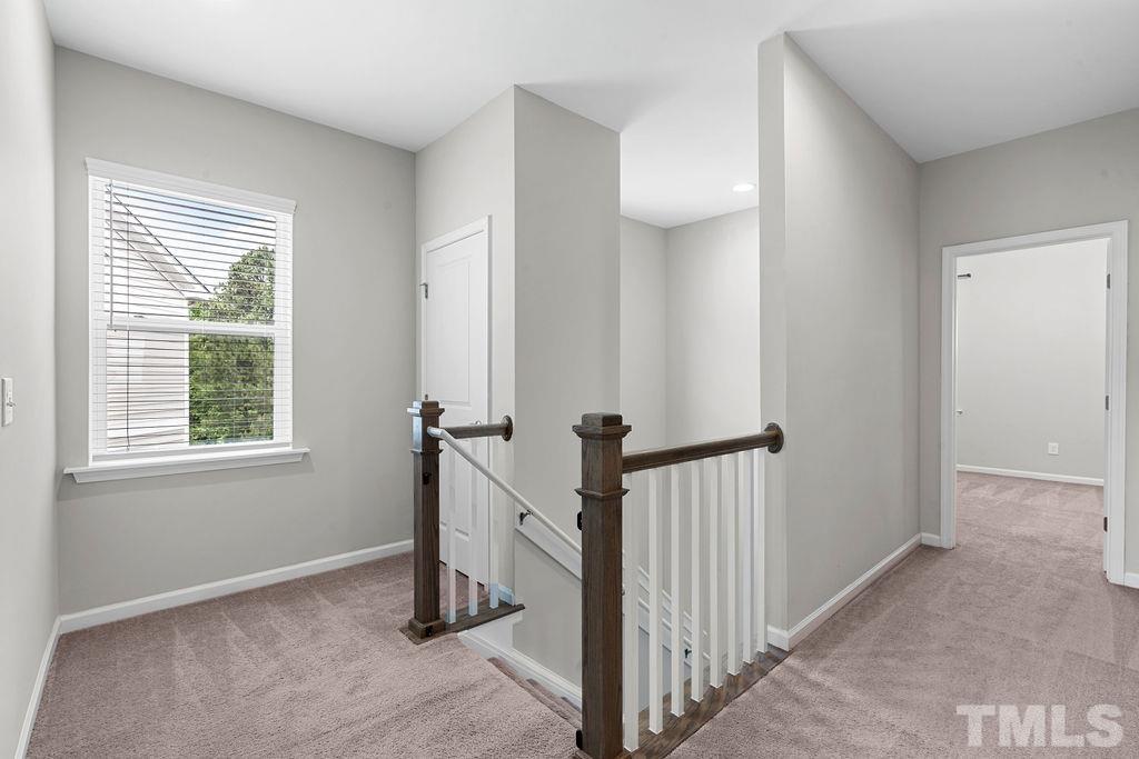 2223 Chattering Lory Lane Apex, NC 27502 - Photo 25 of 49 a view of a livingroom with a staircase