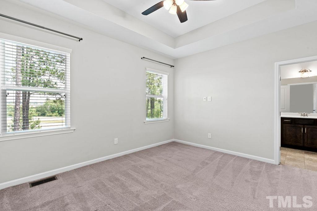 2223 Chattering Lory Lane Apex, NC 27502 - Photo 28 of 49 an empty room with ceiling fan and window