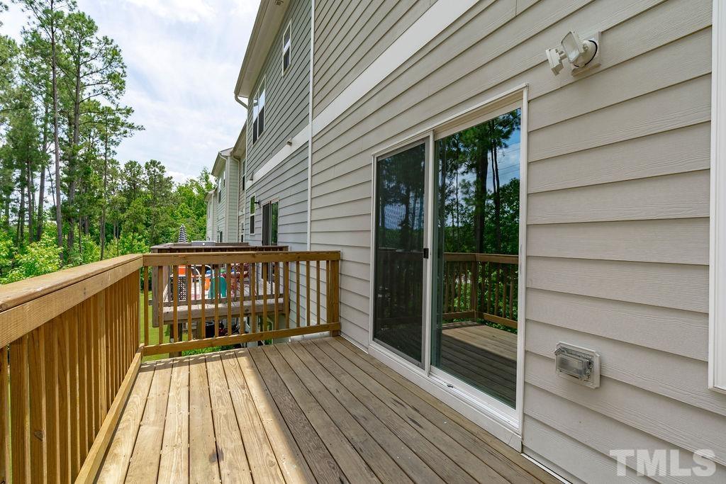2223 Chattering Lory Lane Apex, NC 27502 - Photo 38 of 49 a view of balcony with wooden floor and fence