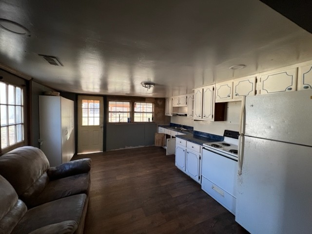 688 Spur Road Decherd, TN 37324 - Photo 8 of 15 a kitchen with granite countertop a refrigerator a stove a sink dishwasher a dining table and chairs with wooden floor