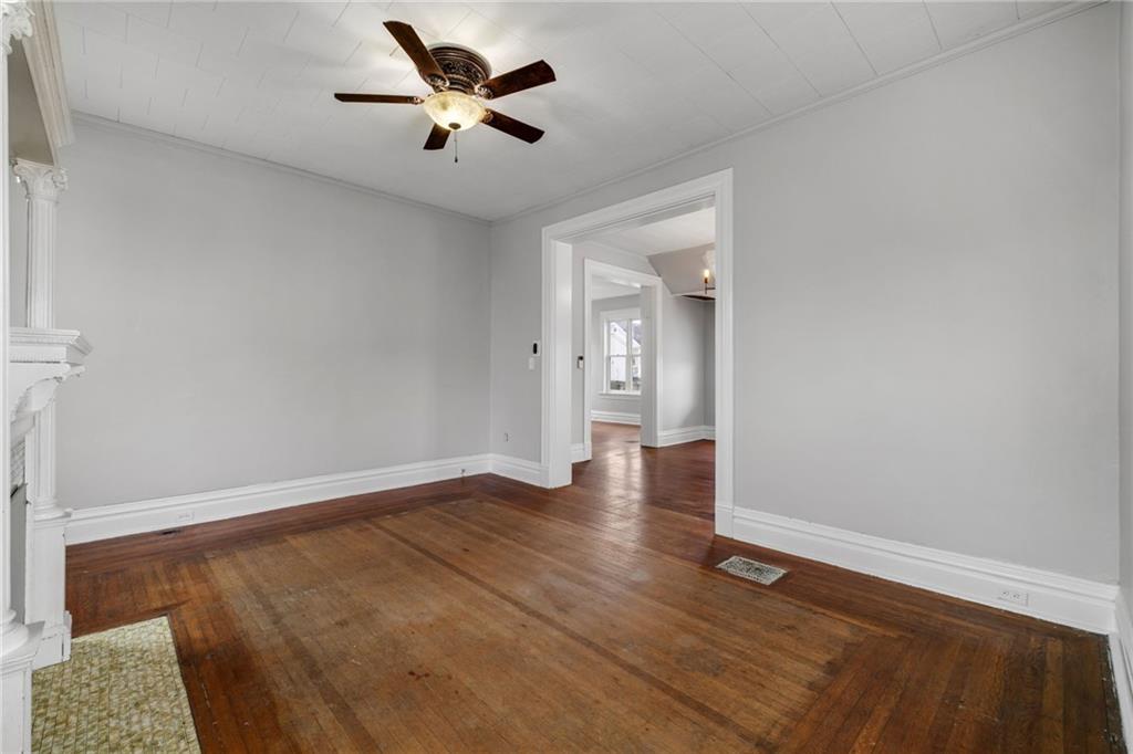 1630 State Avenue Coraopolis, PA 15108 - Photo 12 of 47 an empty room with wooden floor and a ceiling fan