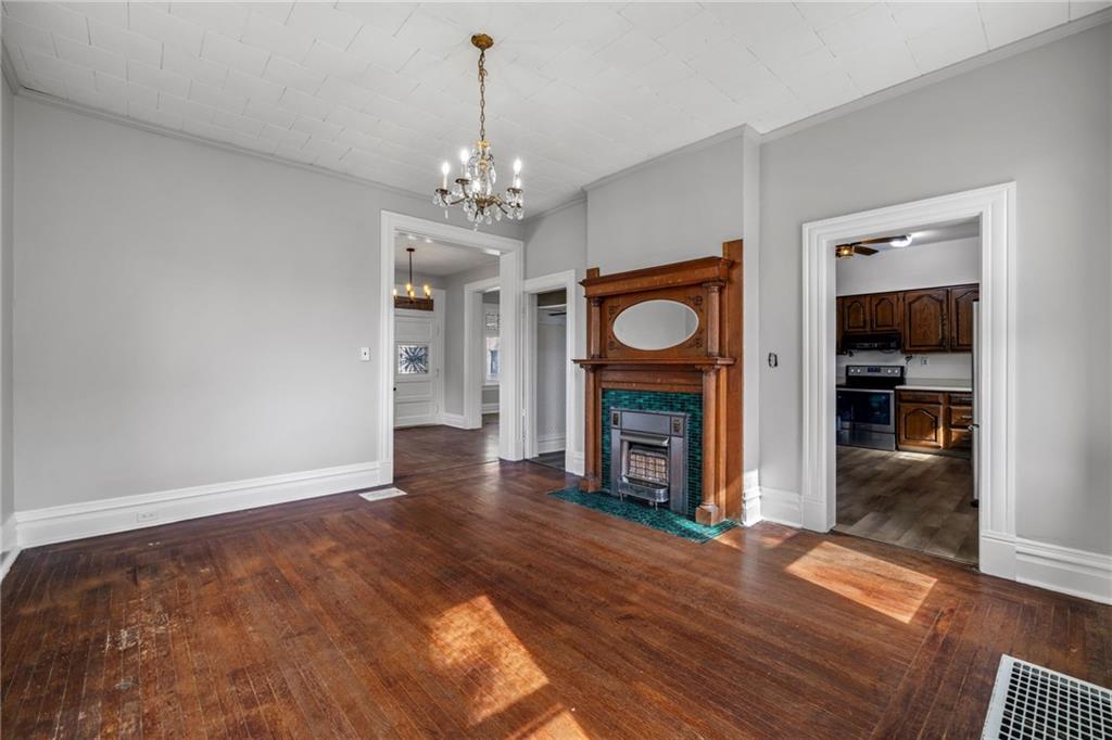 1630 State Avenue Coraopolis, PA 15108 - Photo 14 of 47 a view of a livingroom with a fireplace a chandelier and wooden floor