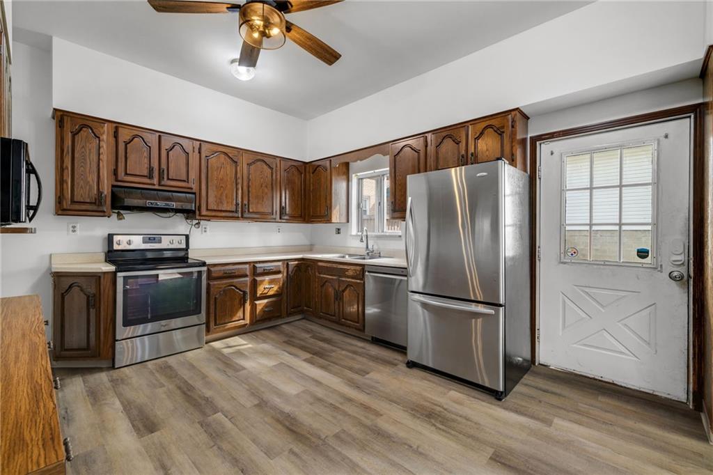 1630 State Avenue Coraopolis, PA 15108 - Photo 17 of 47 a kitchen with granite countertop wooden floors stainless steel appliances and a window