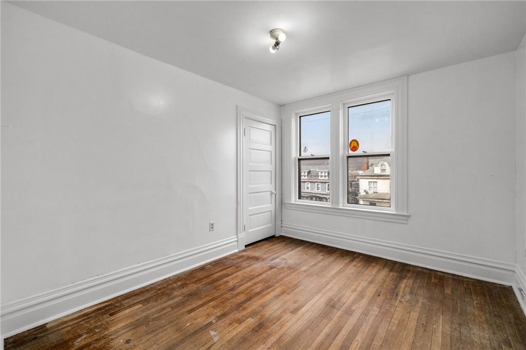 1630 State Avenue Coraopolis, PA 15108 - Photo 30 of 47 an empty room with wooden floor and windows