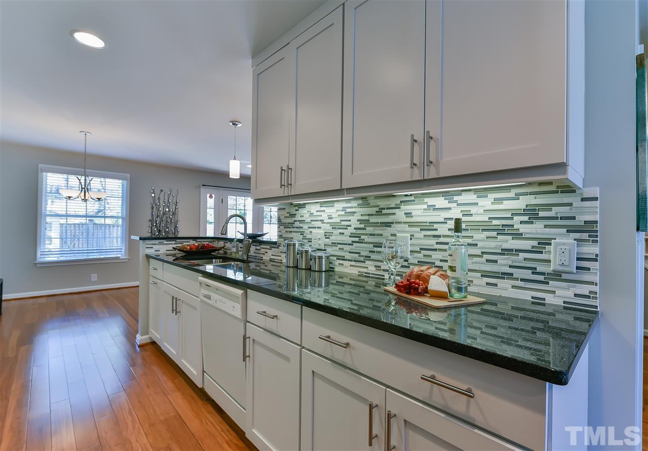 2935 Wycliff Road Raleigh, NC 27607 - Photo 3 of 9 a kitchen with stainless steel appliances granite countertop a sink a stove and cabinets