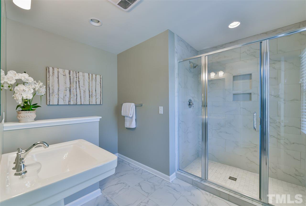 2935 Wycliff Road Raleigh, NC 27607 - Photo 7 of 9 a bathroom with a shower and a sink