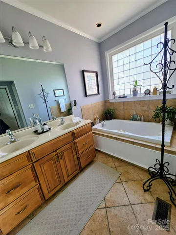 a bathroom with a tub sink and mirror