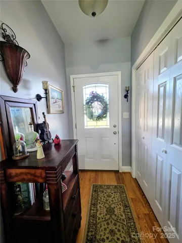 a view of hallway with furniture and a window