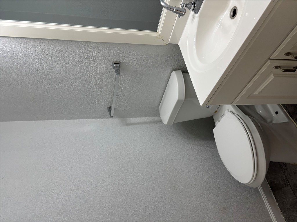 1210 Southport Drive, Unit B Austin, TX 78704 - Photo 7 of 14 a white toilet sitting next to a bathroom sink