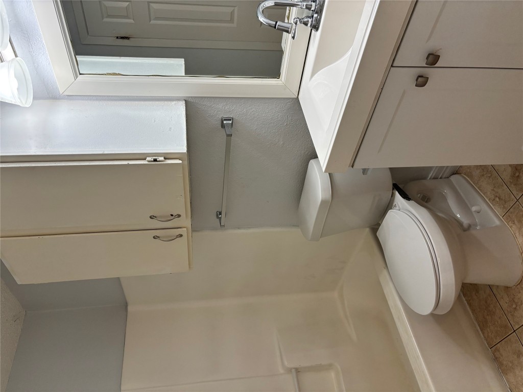 1210 Southport Drive, Unit B Austin, TX 78704 - Photo 10 of 14 a bathroom with a sink a toilet and shower