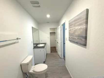 a white toilet sitting next to a bathroom sink