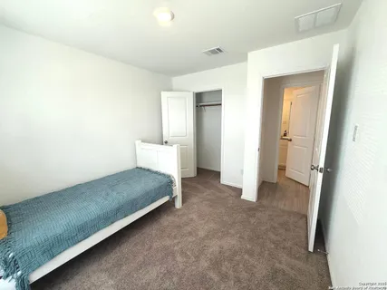 a spacious bedroom with a bed and a table