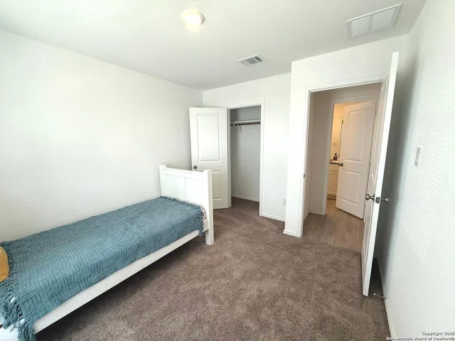 a spacious bedroom with a bed and a table