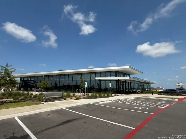 a living room with patio furniture and a floor to ceiling window