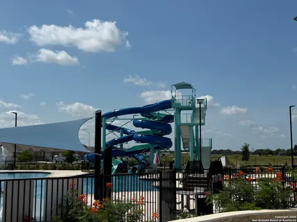 a view of a swimming pool with outdoor seating