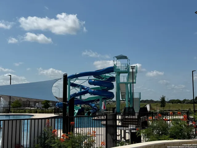 a view of a swimming pool with outdoor seating