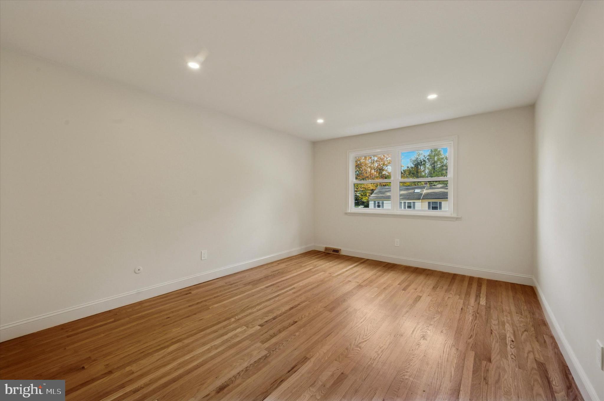 210 David Drive Havertown, PA 19083 - Photo 17 of 38 an empty room with wooden floor and windows