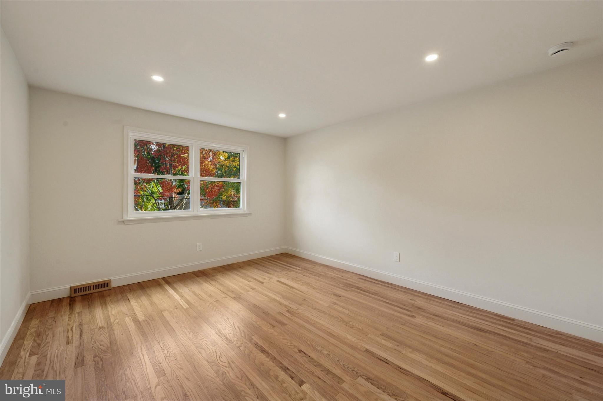 210 David Drive Havertown, PA 19083 - Photo 18 of 38 an empty room with wooden floor and windows