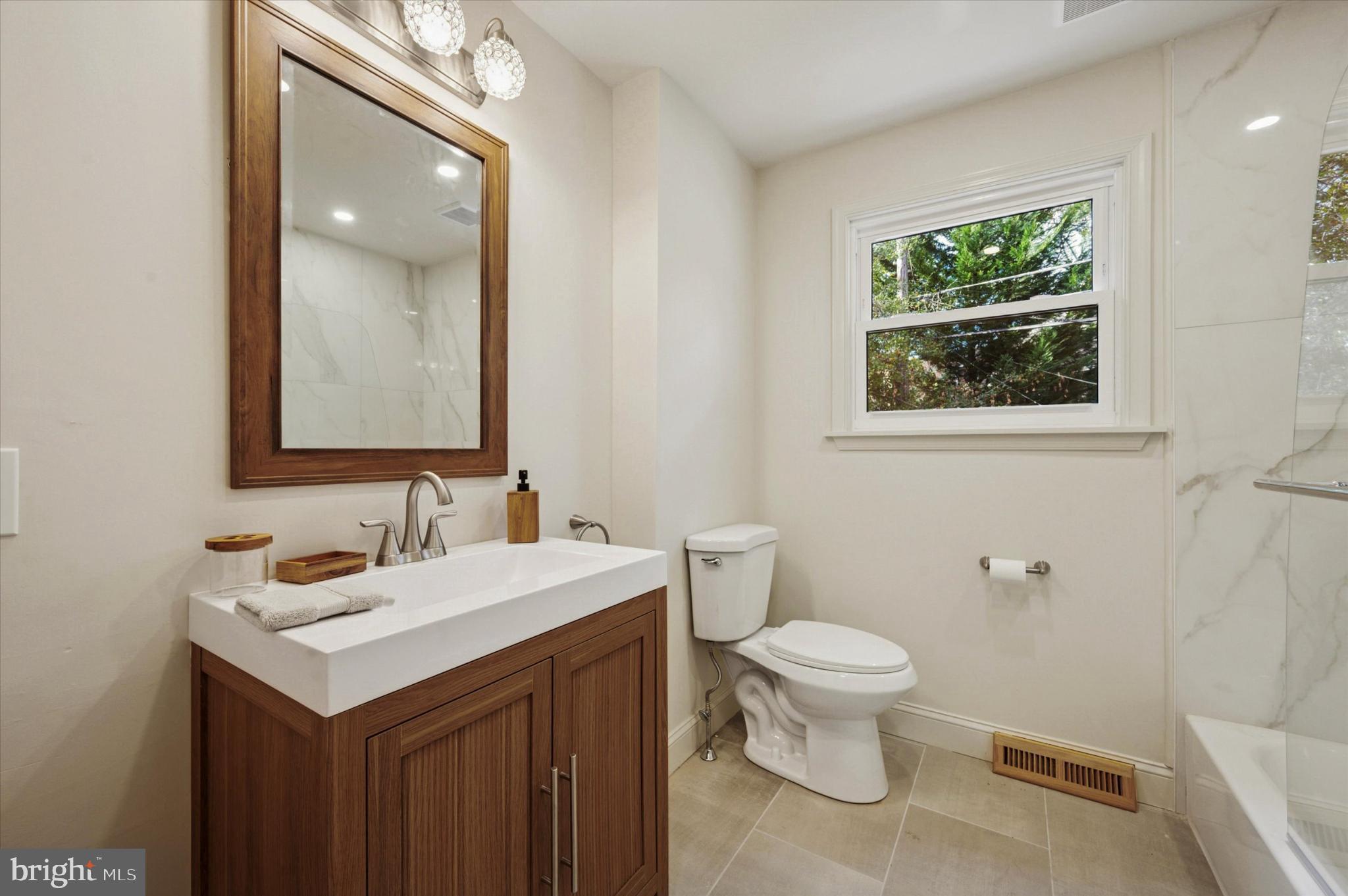 210 David Drive Havertown, PA 19083 - Photo 19 of 38 a bathroom with a toilet sink and mirror