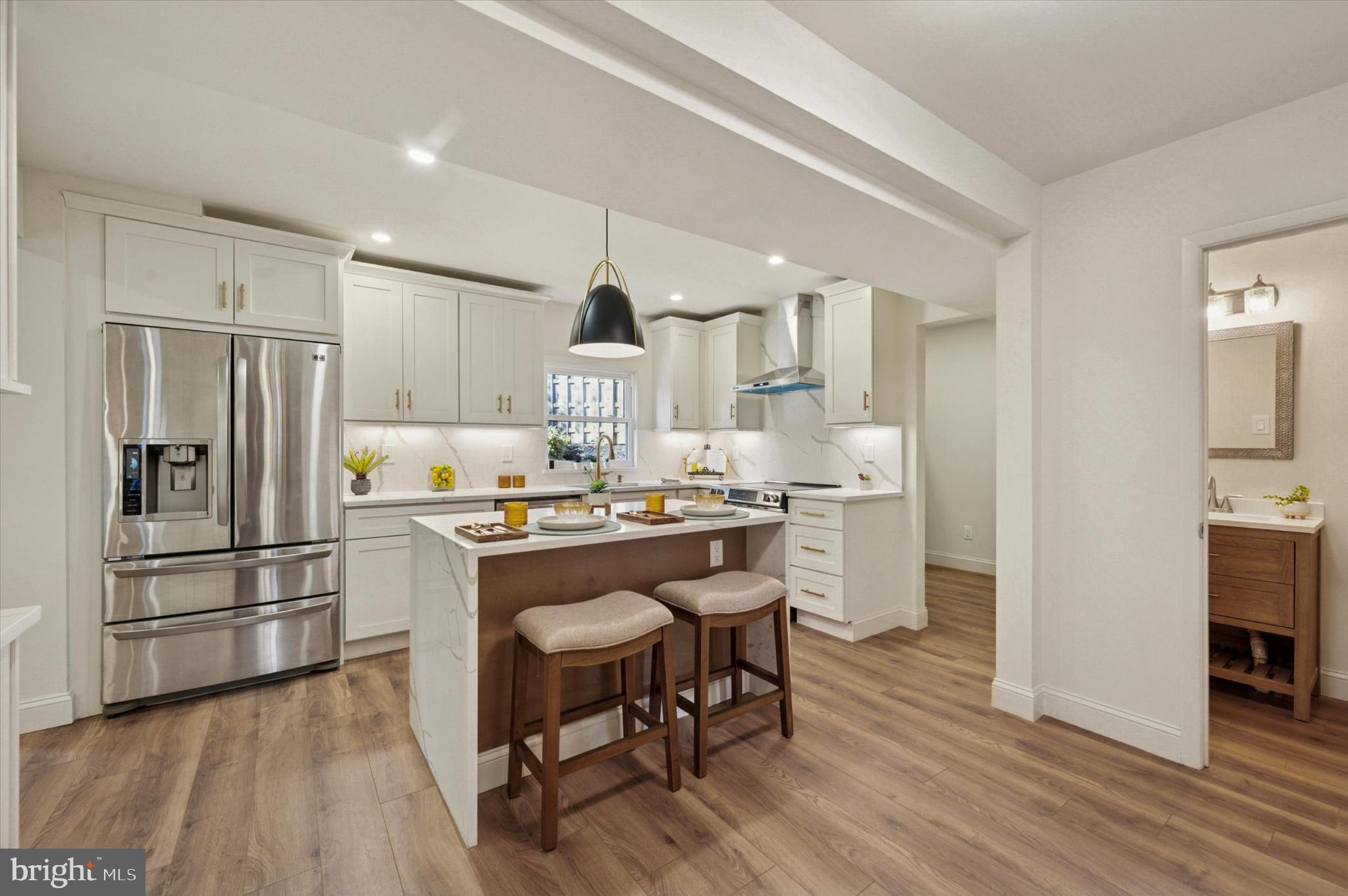 210 David Drive Havertown, PA 19083 - Photo 5 of 38 a kitchen with stainless steel appliances a refrigerator a stove a sink dishwasher and a dining table with wooden floor