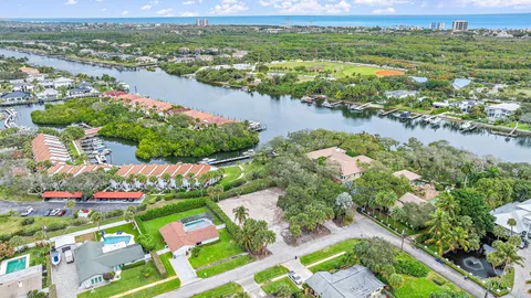 an aerial view of lake and residential houses with outdoor space