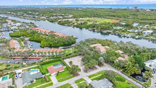 an aerial view of lake and residential houses with outdoor space