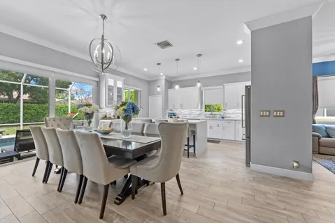 a view of a dining room with furniture wooden floor and chandelier