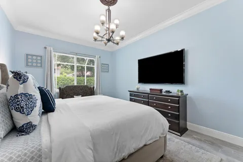 a bedroom with a bed and a flat screen tv
