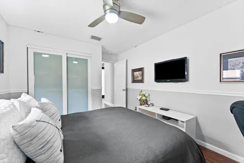 a bedroom with a bed and a flat screen tv
