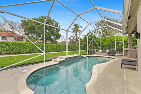 a view of a backyard with a swimming pool