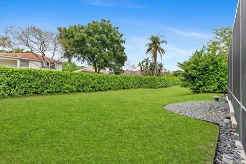 a view of a house with a backyard