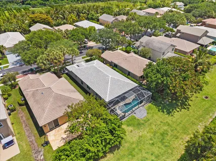 an aerial view of residential houses with outdoor space and street view
