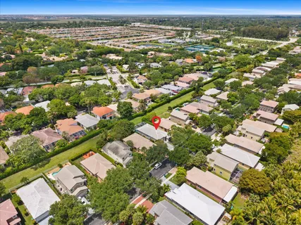 an aerial view of residential houses with outdoor space and street view