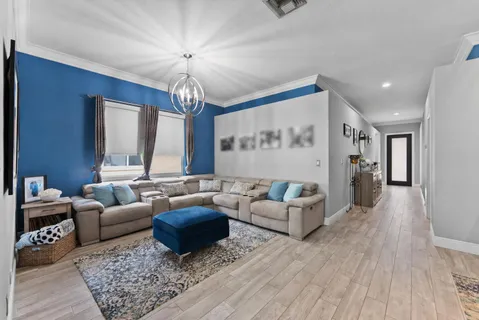 a living room with furniture ceiling fan and a rug