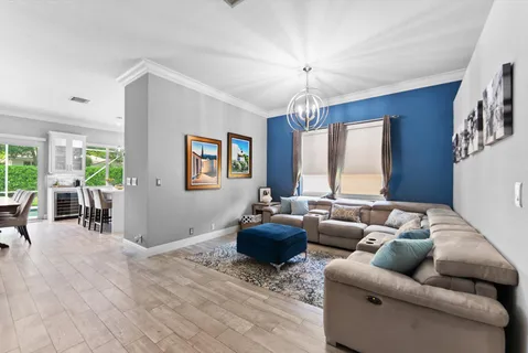 a living room with furniture and a chandelier