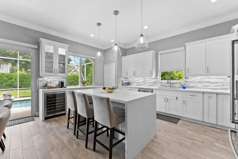 a kitchen with kitchen island white cabinets and white appliances