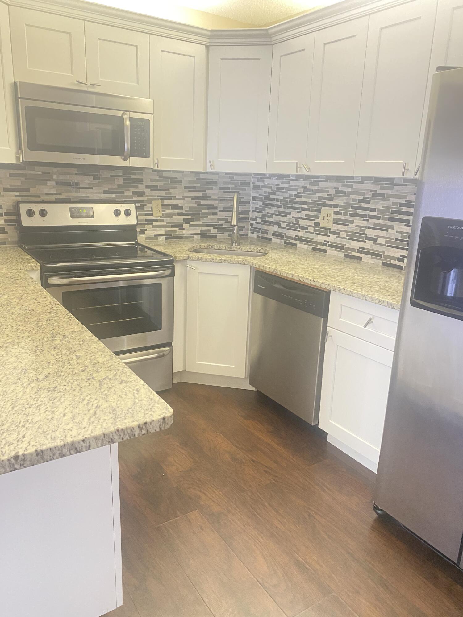 a kitchen with stainless steel appliances granite countertop a sink stove and cabinets