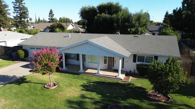 a aerial view of a house with yard and a garden