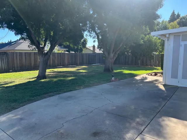 a view of a house with backyard and sitting area