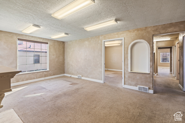 465 North Main Street Richfield, UT 84701 - Photo 14 of 43 Carpeted empty room featuring visible vents, a textured ceiling, and baseboards