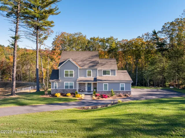 a front view of house with yard and swimming pool