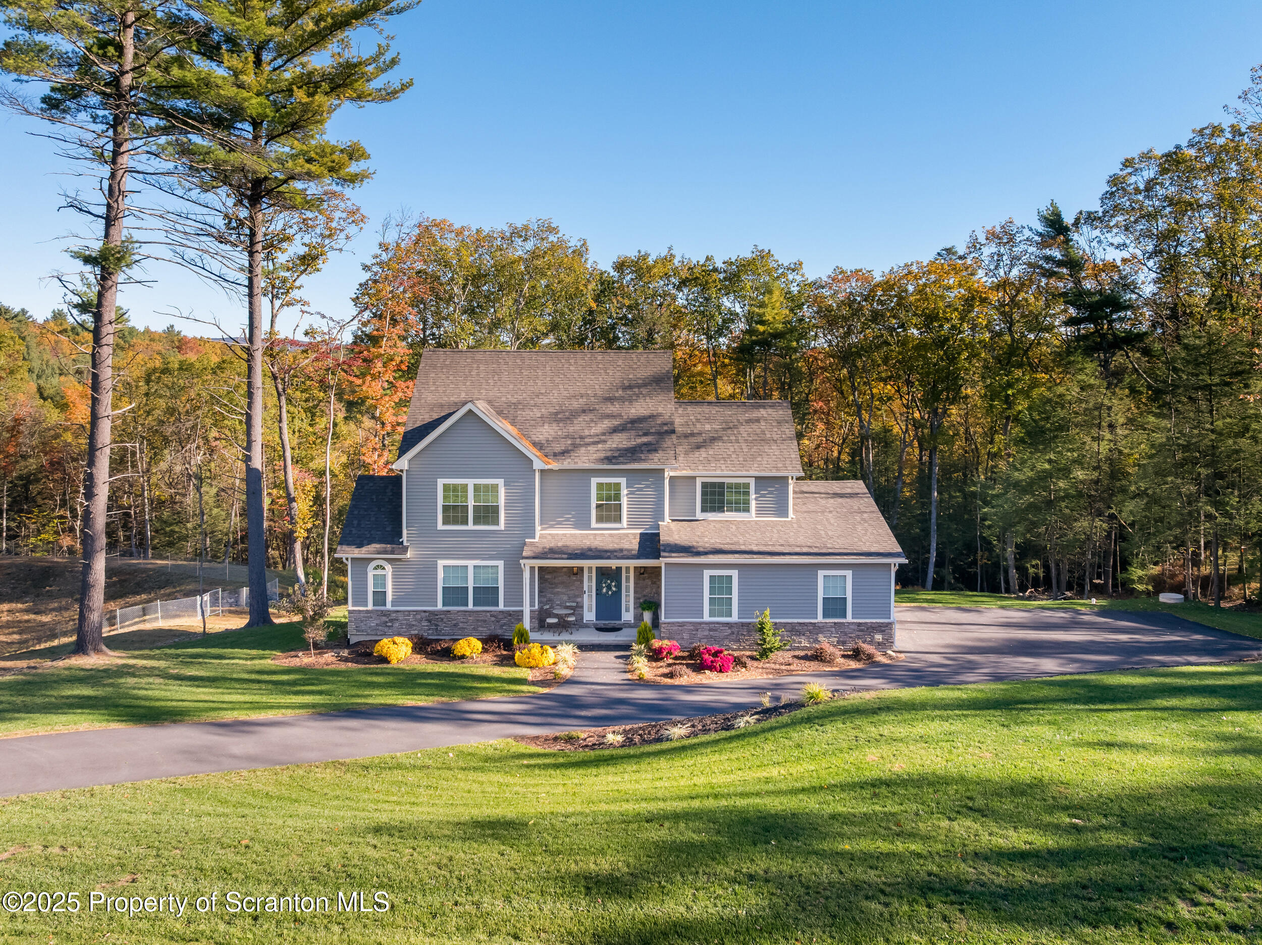 a front view of house with yard and swimming pool