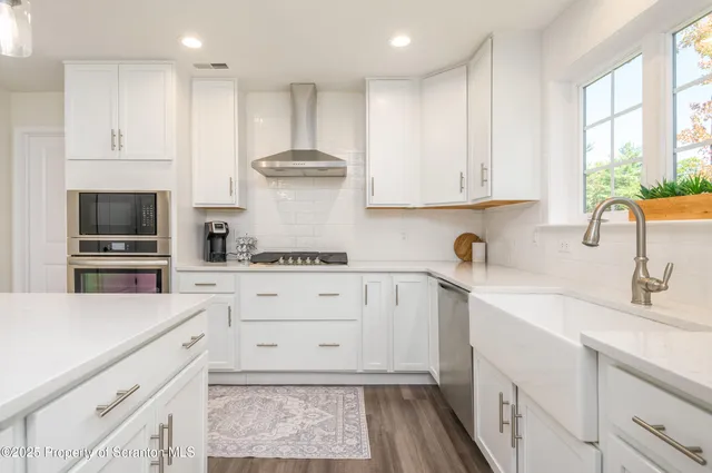 a kitchen with cabinets appliances and a window